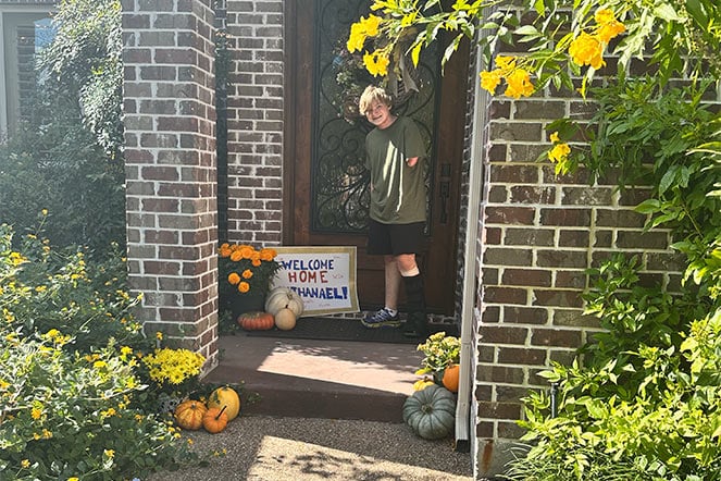 Nathanial at the doorway of his home.