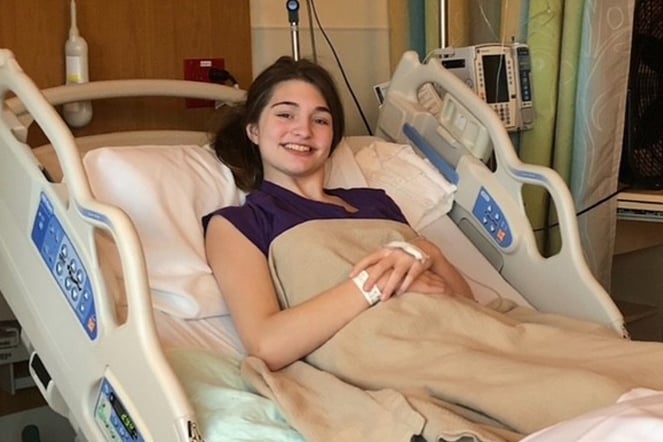 female patient smiling in a hospital bed
