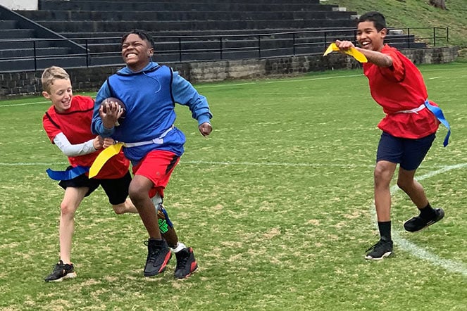 Parker running, playing flag football