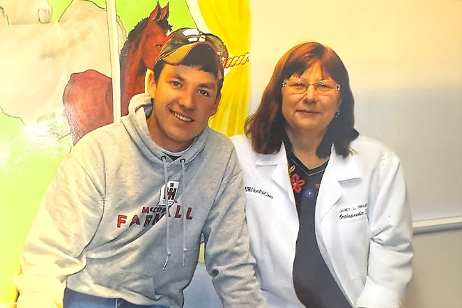 an aged photo of a patient wearing a hooded sweatshirt next to a care provider wearing a lab coat in front of a mural