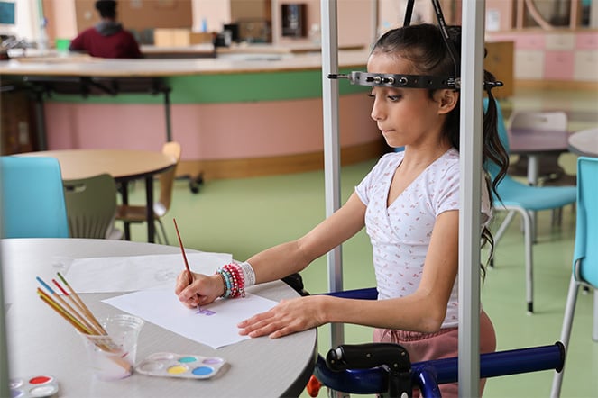 Patient with halo traction drawing in art therapy