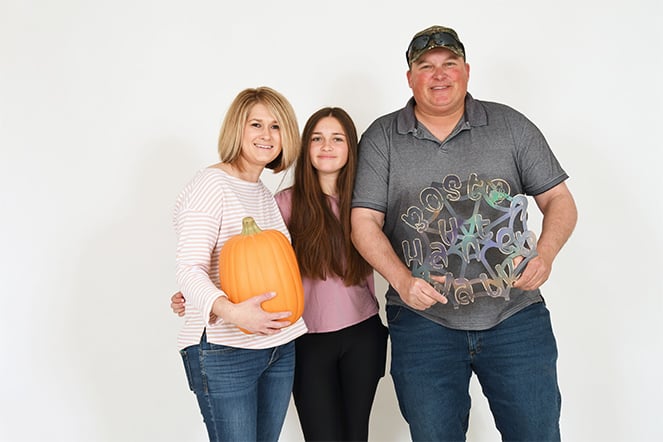 patient with parents holding pumpkin and Boston Haunted Walk web sign