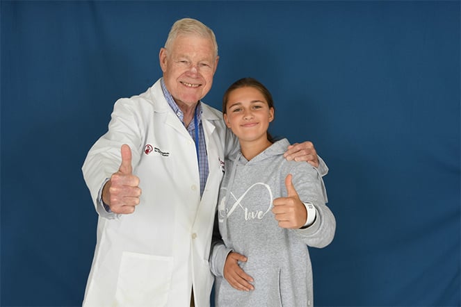 Patient with physician giving a thumbs-up