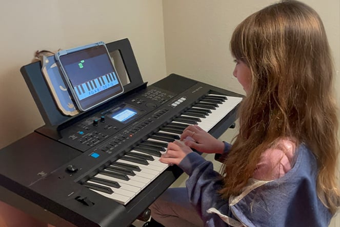 a child playing an electric keyboard