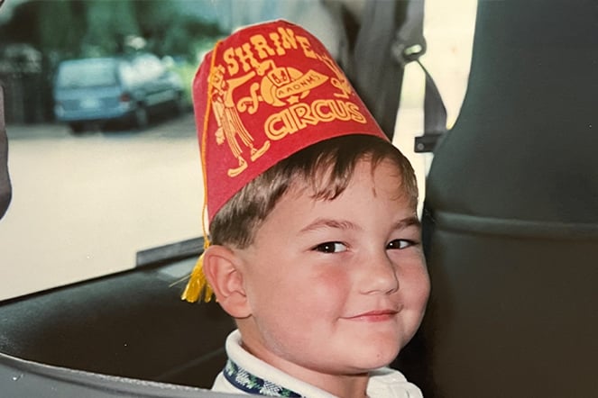 a vintage photo of a young child wearing a fez