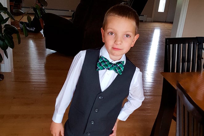 Peyton wearing formal vest, shirt and bowtie