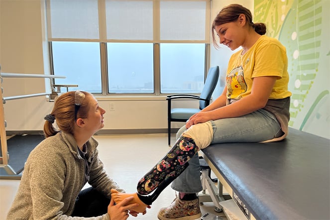 Patient Angel being fitted for a prosthetic by her prosthetist, Lauren