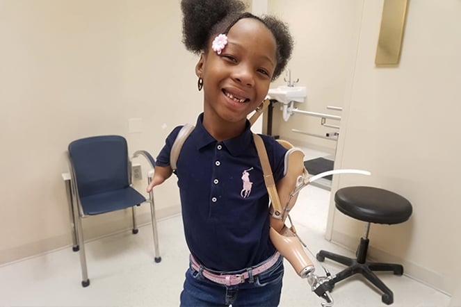 Prosthetic patient smiling in a doctor's office