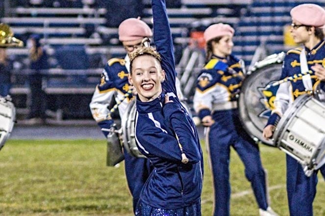 Rachel on football field during performance