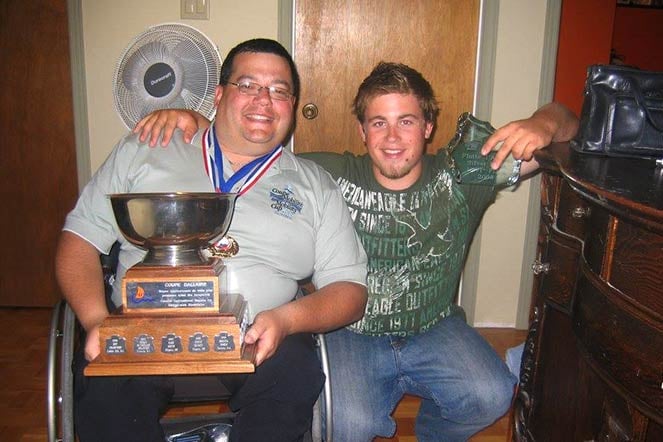 Richard with his teammate, holding trophy