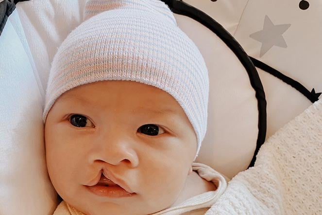 Saint in a little white cap looking very content and serene