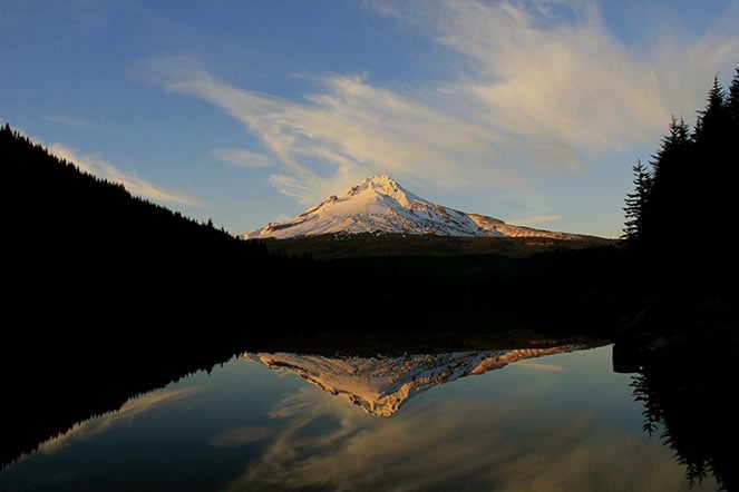 scenic photo of mountain with lake in foreground