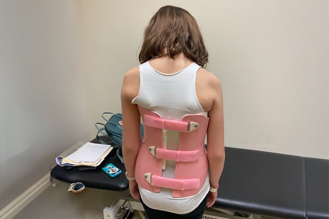 a child wearing a back brace