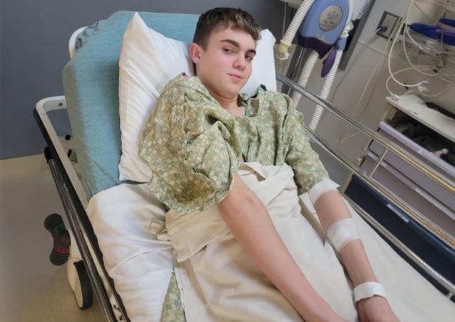 Scoliosis patient grinning in a hospital bed
