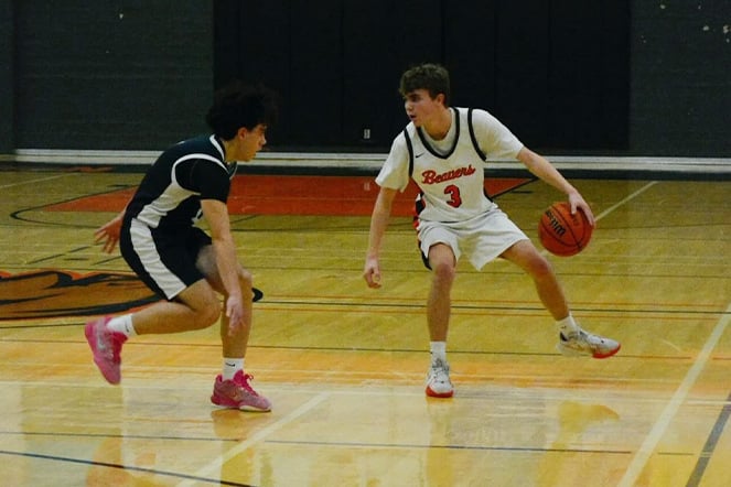 Scoliosis patient wearing a number 3 jersey playing basketball in a gymnasium