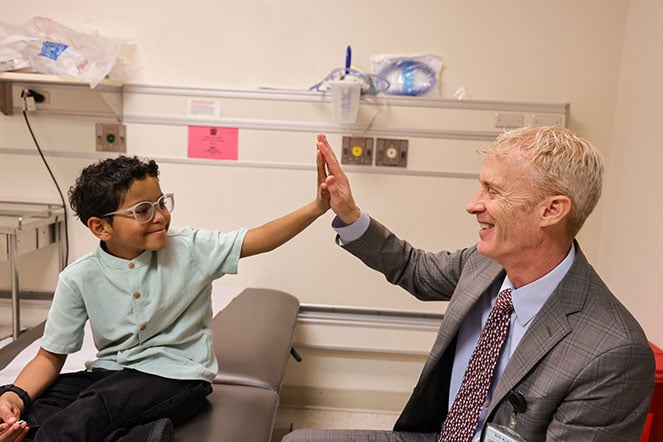 Silas and provider share a high five