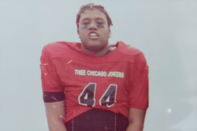 A child wearing a football jersey with the name "Thee Chicago Jokers"