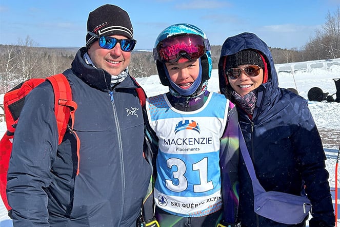 a family wearing winter attire at a ski slope