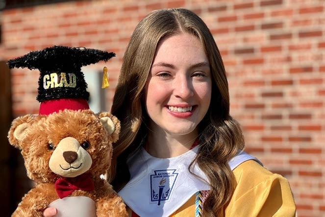 sydney at her graduation with fezzy