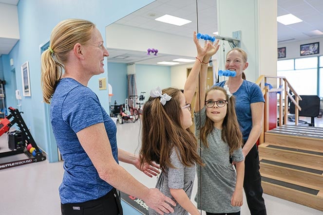 physical therapist working with Taelley