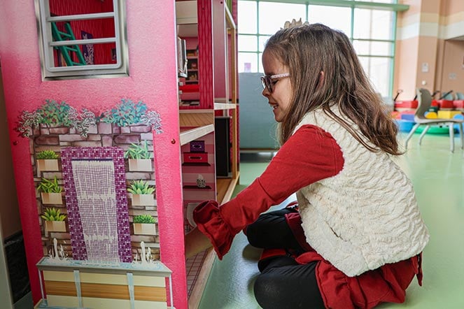 Taelley playing with dollhouse