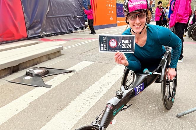 spina bifida patient tatyana on adaptive wheelchair, holding ticket to Paris Paralympics