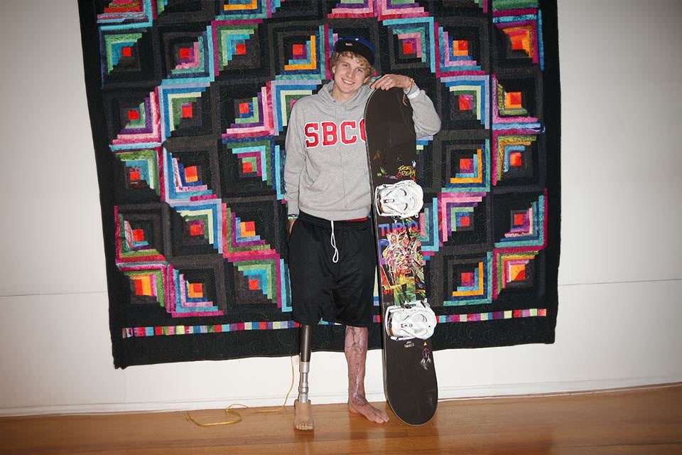 Tommy poses with a snowboard