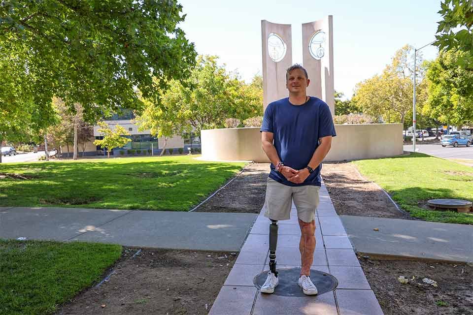Tommy posing in front of statues at Shriners Children's Northern California