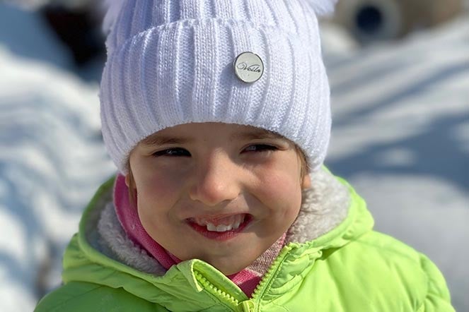 veronica sitting in snow smiling