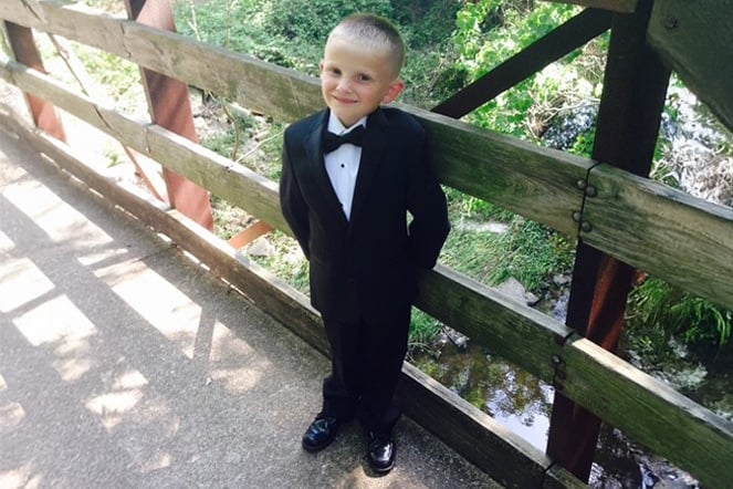a young child in a tuxedo