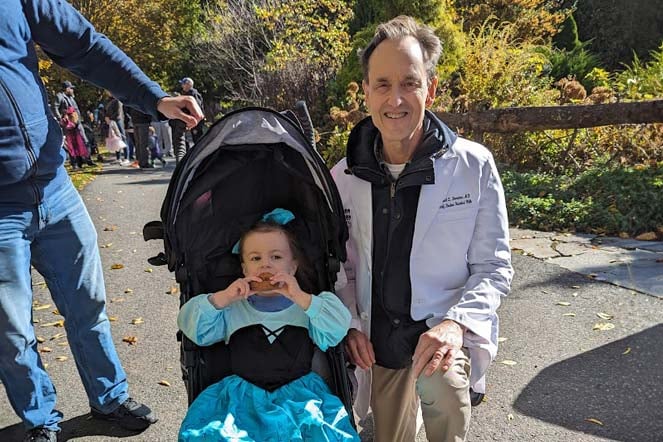 Zoey in stroller with provider