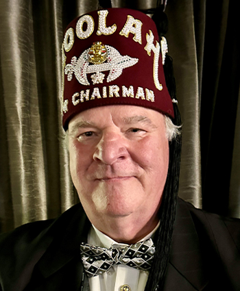 a man in a suit wearing a fez