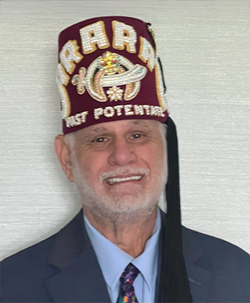 a man in a suit wearing a fez