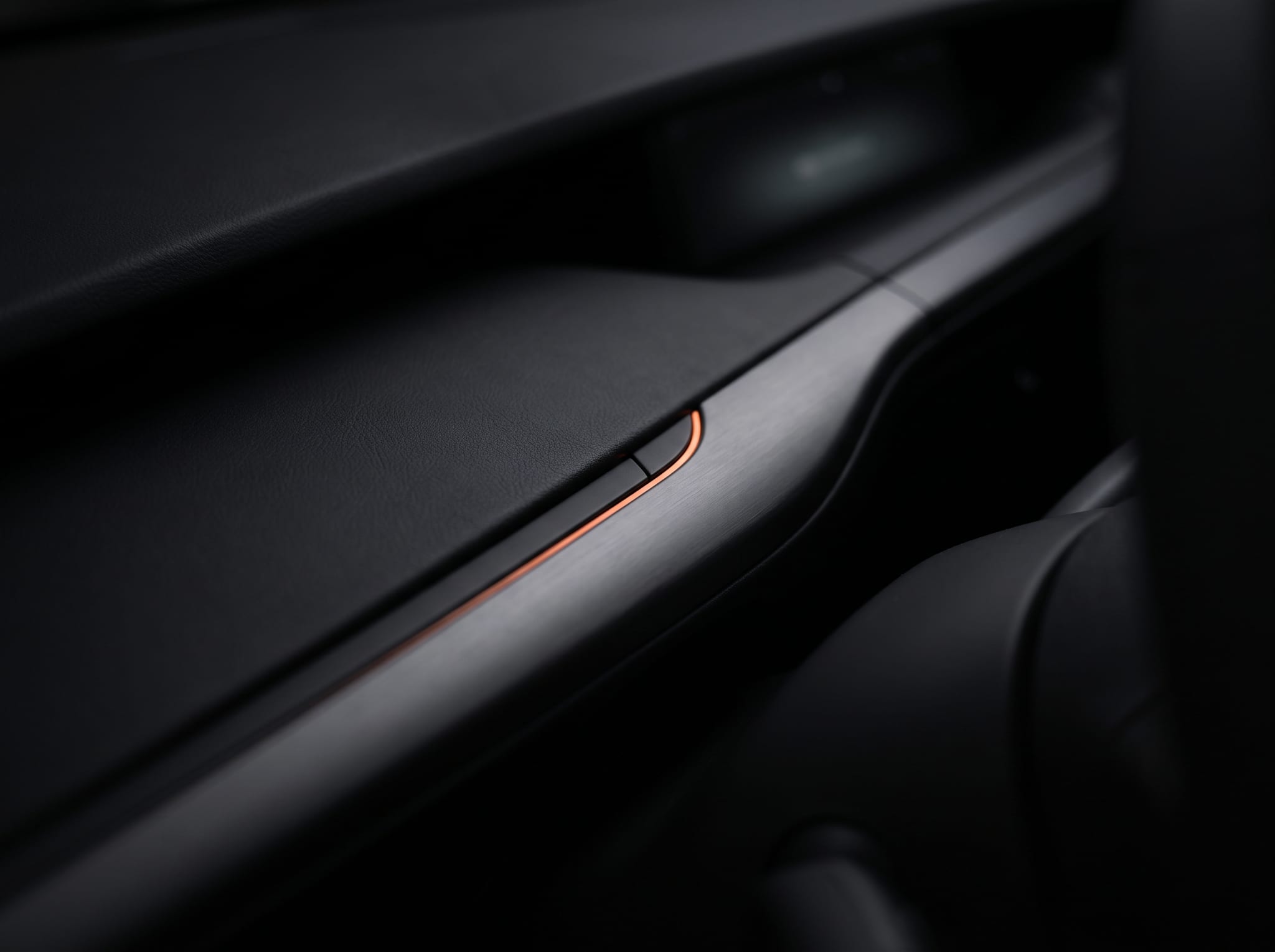 A minimal matte-black cabin surface, brushed metal and a single fading light-edge