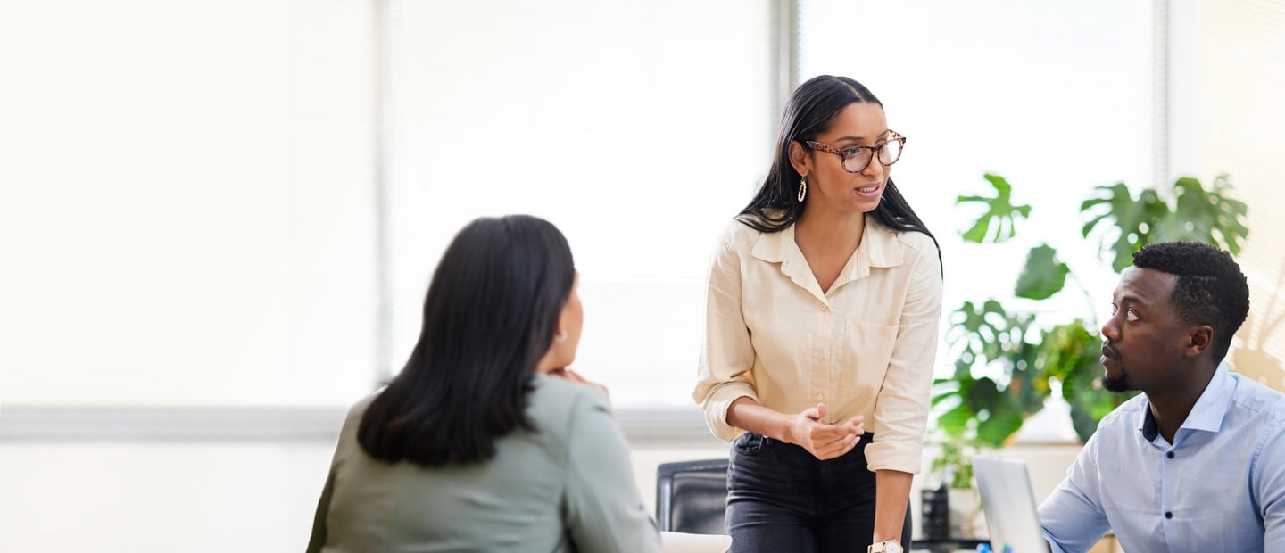 Young professionals talking around a meeting table