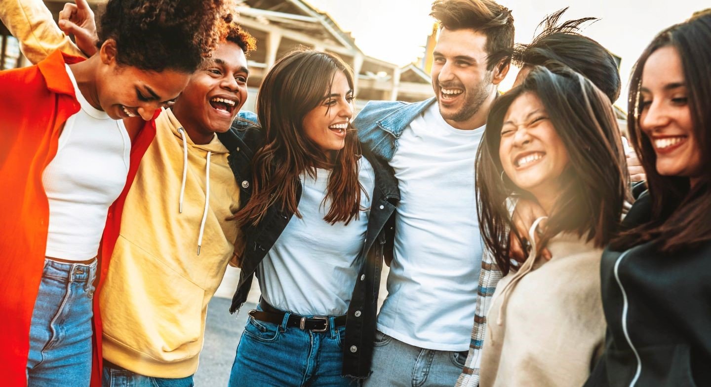 Gen Z crowd hugging in a group