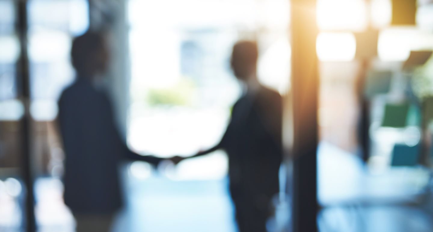 Two men shaking hands after a deal.