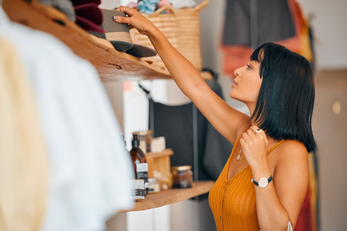 A person looking at a shelf with clothes