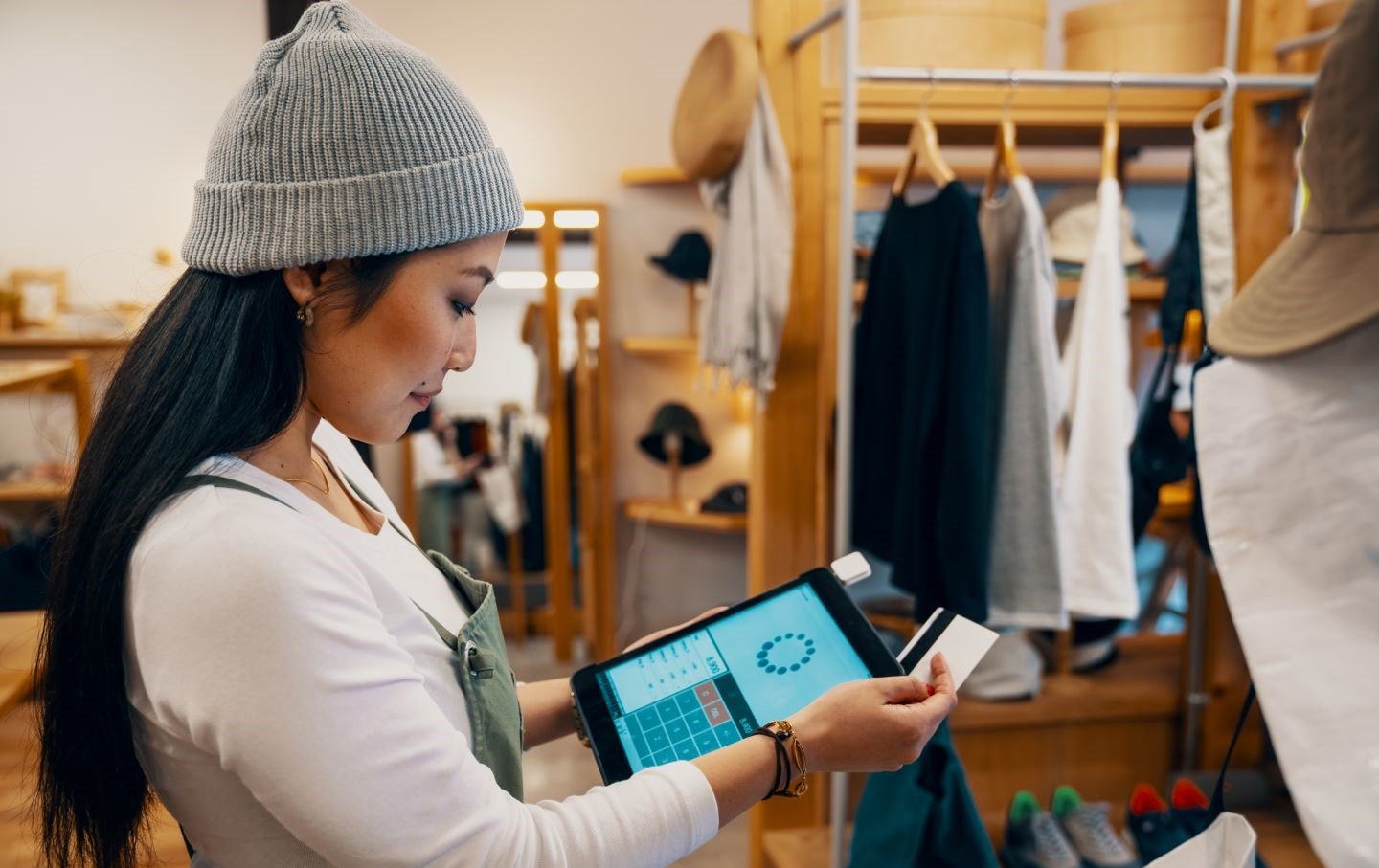 Female clerk using POS in store
