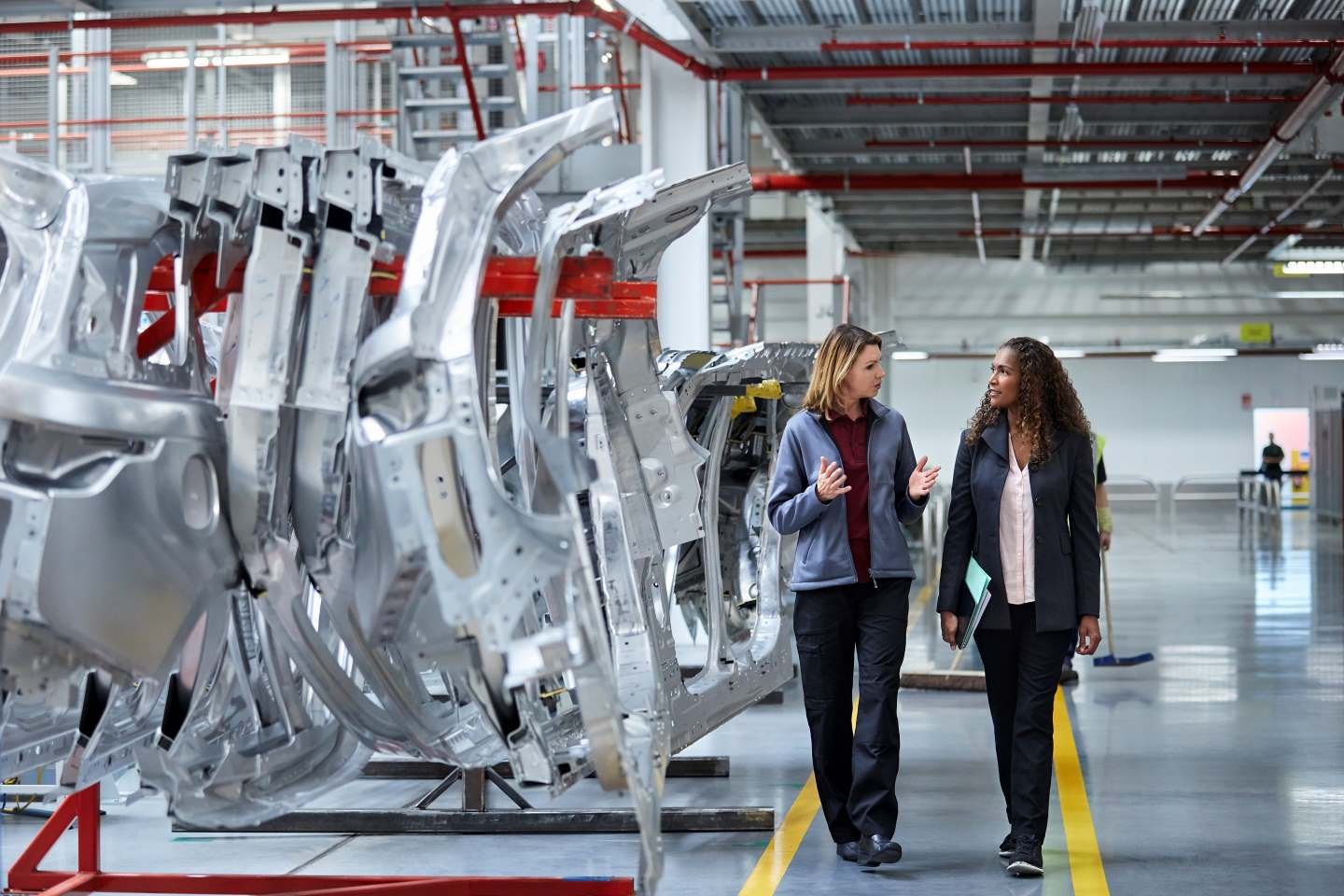 Two executives walking through an automotive manufacturer
