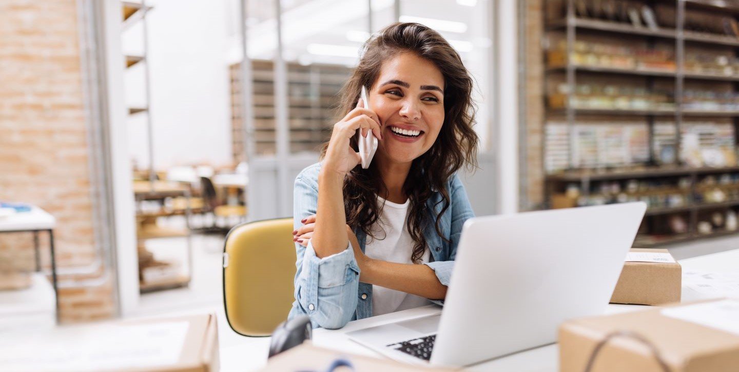 Business woman in the warehouse on the phone
