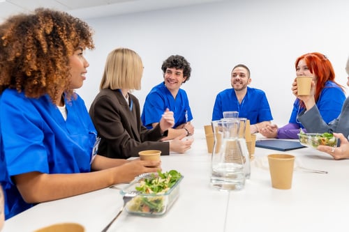 Healthcare workers sitting at a table and eating.