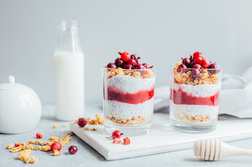 A chia seed pudding containing fruits and nuts.