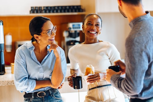A group of employees enjoying a cup of coffee.