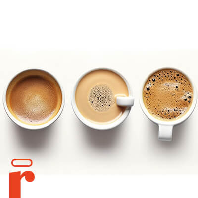 Three cups of coffee in a row, each with a different amount of foam and color.