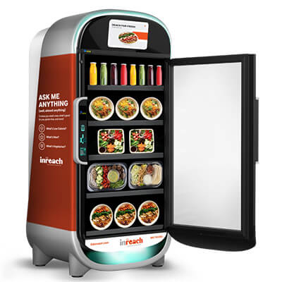 Smart vending fridge displaying bottled drinks and prepared meals with the door open.