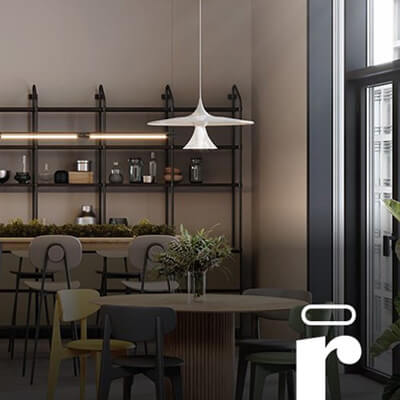 Modern office pantry with round tables, bar seating, hanging lights, and shelves with plants and kitchenware.