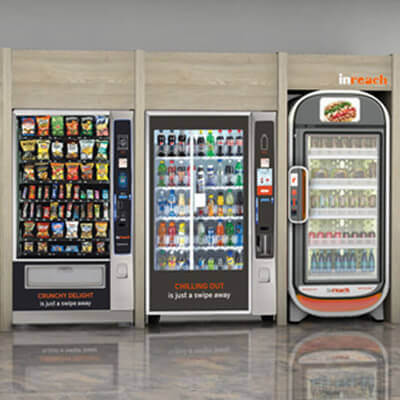 Three vending machines side by side offering snacks, cold beverages, and fresh meals, with clear glass doors and organized shelves in a modern setting.