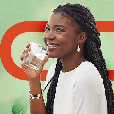 Person drinking a glass of water against a green background with a bold orange graphic element.