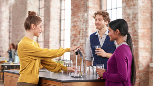 people conversing at a water station